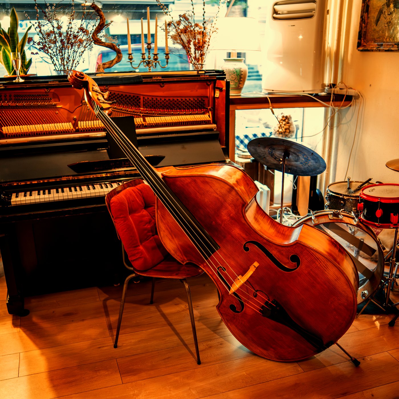 Piano, upright bass and drums set up for a Modi evening